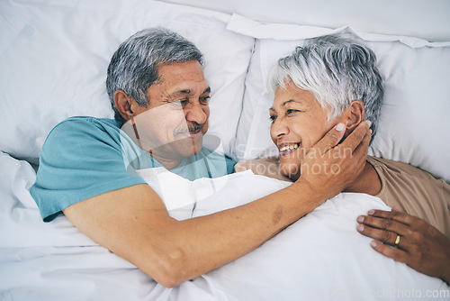Image of Bed, love and happy senior couple in a bedroom bonding as care, support and relax to enjoy retirement in a home. Smile, solidarity and elderly people, man and woman with trust in marriage together