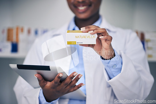 Image of Black woman, pharmacist and hands with tablet, medicine and skincare supplements in pharmacy, drugstore and healthcare. Medical professional, technology or doctor with pills for anesthesia in surgery