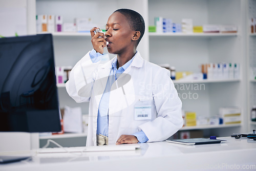 Image of Black woman, pharmacist and asthma inhaler for relief, breathing or cure at the pharmacy. Calm African female person in medical healthcare with chest pain, lungs or allergy taking deep breath in pump