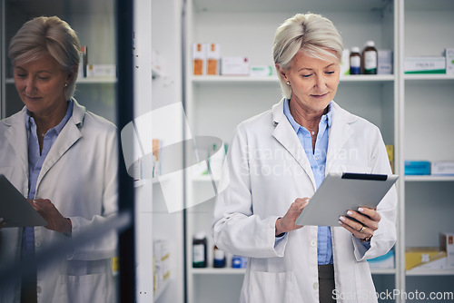 Image of Senior woman, pharmacist and tablet for research, online healthcare and telehealth in pharmacy, drugstore or shop. Medical professional, technology and elderly doctor reading email for medicine app.