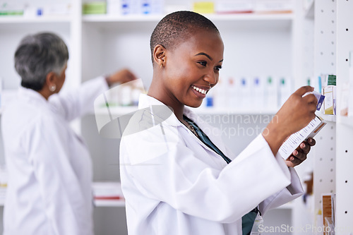 Image of Happy black woman, pharmacist and pills for inventory inspection or checking stock on shelf at pharmacy. African female person in medical healthcare with pharmaceutical product for medication storage