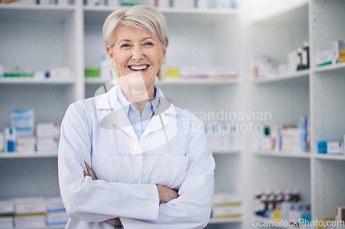 Image of Portrait, senior pharmacist and woman with arms crossed in pharmacy, drugstore or shop for medicine. Smile, medical professional and face of doctor, healthcare expert and confident person from Canada