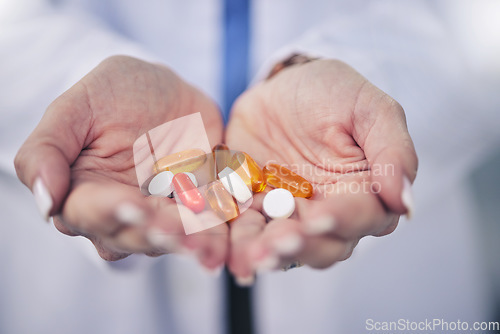 Image of Woman, pharmacist and palm hands with pills for cure, pain relief or medication at pharmacy store. Closeup of female person, medical or healthcare professional with tablets, drugs or pharmaceuticals