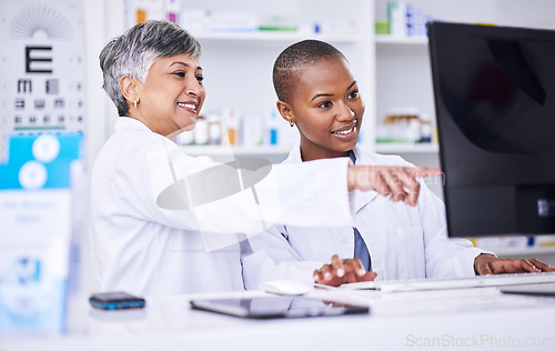 Image of Senior woman, pharmacist and coaching intern on computer for data, inventory or stock at pharmacy. Happy mature female person, coach or employee training staff on PC in healthcare services at clinic