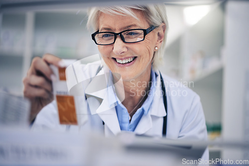 Image of Happy woman, pharmacist and reading medication on shelf for inventory, diagnosis or prescription at pharmacy. Mature female person, medical or healthcare professional checking medicine in drugstore