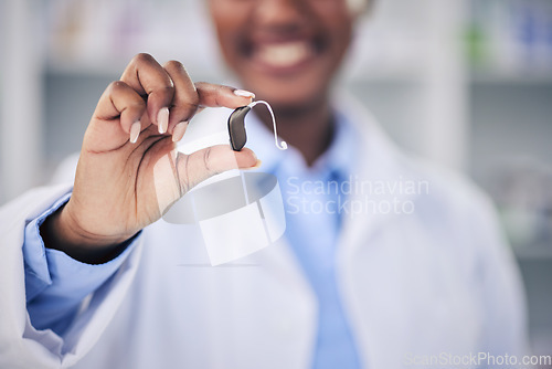 Image of Woman, pharmacist and hands with hearing aid holding listening device for healthcare at the pharmacy. Closeup of deaf person or medical professional with ear piece in audiology for sound at clinic