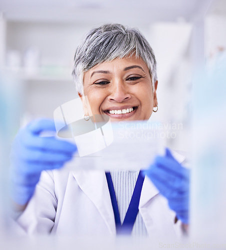 Image of Pharmacist, mature woman and medicine box for prescription at pharmacy with blurry background. Healthcare, drugstore and pharmaceutical worker holding tablet or treatment in closeup at clinic.