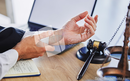Image of Hands of person, wrist and pain of lawyer at desk, office and law firm. Closeup of advocate, legal worker and attorney in injury, carpal tunnel and health risk of arthritis, muscle stress and problem