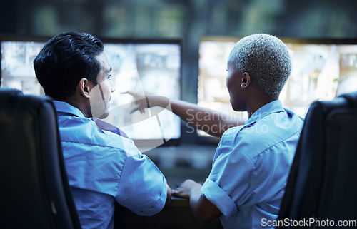 Image of Security guard in control room, man and woman with screen to check cctv together in team office. Safety, surveillance and teamwork, video to monitor crime and privacy at night for protection service.