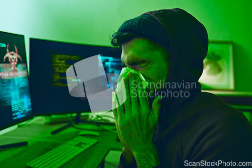 Image of Man, crime or sick hacker with virus in office for coding, online fraud or computer cybersecurity at night. Tissue, thief or ill programmer blowing nose or working on software data scam with fever