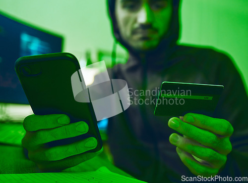 Image of Man, phone or hacker with credit card for scam, online fraud or cybersecurity crime at night on dark web. Thief, financial or hands of man typing password data or banking info on fintech mobile app