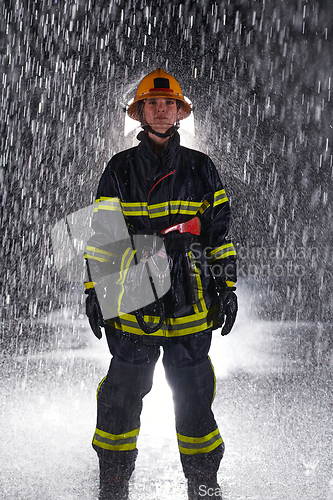 Image of A determined female firefighter in a professional uniform striding through the dangerous, rainy night on a daring rescue mission, showcasing her unwavering bravery and commitment to saving lives.