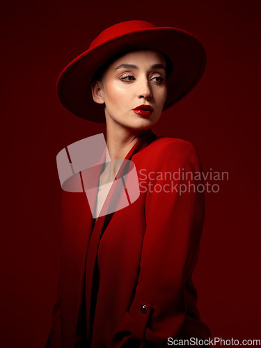 Image of Idea, fashion and woman in red hat in studio isolated on a background with suit. Makeup, cosmetics and female model in fedora, serious style and classy clothes with aesthetic, vision and thinking.
