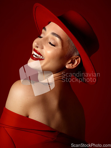 Image of Fashion, funny and a model woman on a red studio background for elegant or trendy style. Aesthetic, art and beauty with a young female person laughing in an edgy or classy unique clothes outfit