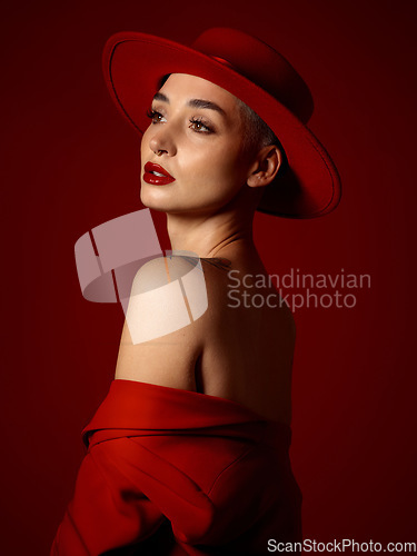 Image of Mindset, fashion and a model woman on a red studio background for elegant or trendy style. Future, vision and beauty with a young female person thinking in an edgy or classy outfit for aesthetic art