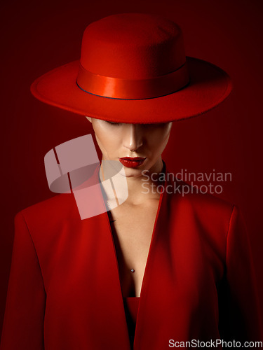 Image of Suit, hat and woman with fashion or beauty in studio with retro, style or edgy, confident or creative pose on red background mockup. Mystery character, model and girl with power or vintage aesthetic