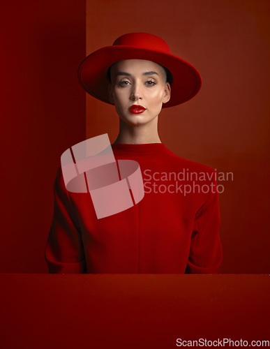 Image of Portrait, reverse fashion and mockup with a woman on a red background in studio for marketing, advertising or branding. Luxury, aesthetic style or trendy young female model standing with empty space