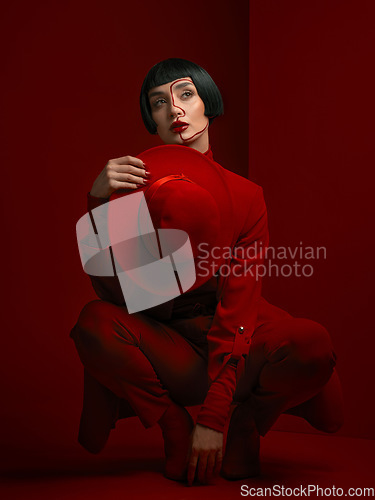 Image of Woman, fashion and art deco, red aesthetic with beauty and makeup with vintage style shine on studio background. Female model, thinking and bold cosmetics, female model with glamour and creative