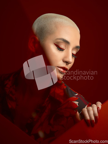 Image of Woman, beauty and red aesthetic with fashion and art deco, makeup and shine isolated on studio background. Female model, skin glow with bold cosmetics, young female model with glamour and creative