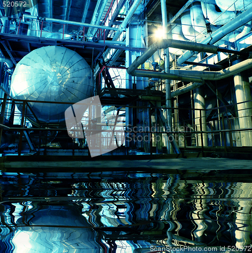 Image of Pipes, tubes, machinery and steam turbine at a power plant