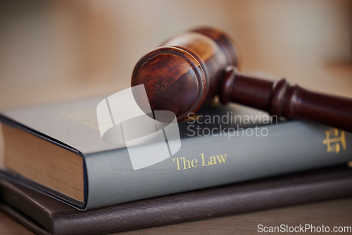 Image of Background, gavel and law books on table of attorney, judge and justice for courtroom. Closeup of legal hammer, notebook and desk of lawyer in constitution of truth, fair information and human rights