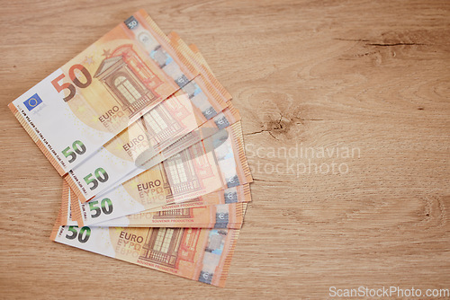 Image of Cash, money on a table and notes with finance, taxes and payment with mockup space and investment. Savings, banking and bills with salary bonus, euros and savings, economy and financial budget