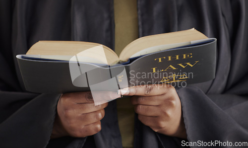 Image of Hands, law or lawyer reading book, constitution research or education for learning the justice system. Guide, advocate or closeup of attorney studying knowledge, guide or information for legal agency