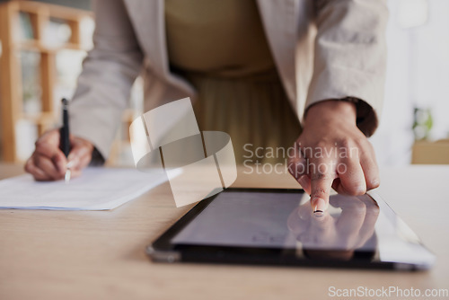 Image of Hand, tablet and fingerprint with a business woman in her office to access a secure database of information. Technology, password or biometrics with a female employee working on documents at her desk