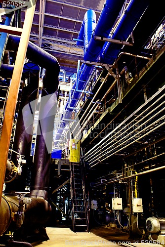 Image of Pipes, tubes, machinery and steam turbine at a power plant