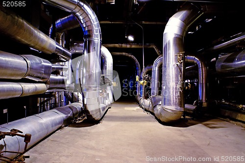 Image of Pipes, tubes, machinery and steam turbine at a power plant 