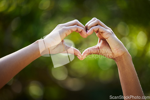 Image of Hands, heart as a symbol or love or health with a person outdoor in nature on a blurred background for sustainability. Like, romance or valentines day with green gesture in a garden or yard in summer