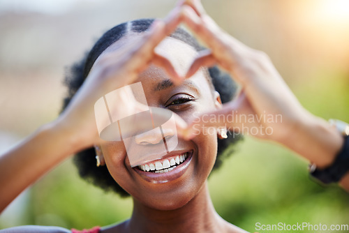 Image of Portrait, smile and heart sign with black woman outdoor with sun or freedom for health, Happiness, girl and love hands in nature with care or like expression in garden or closeup with emoji in summer