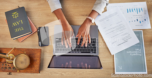 Image of Lawyer, hands and laptop typing with divorce case and notes with website in a office. Desk, top view and law firm with planning paperwork for settlement report with contract document with computer