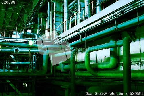 Image of Pipes, tubes, machinery and steam turbine at a power plant