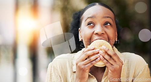 Image of Mockup, fast food and black woman eating a burger in an outdoor restaurant as a lunch meal craving deal. Breakfast, sandwich and young female person or customer enjoying a tasty unhealthy snack