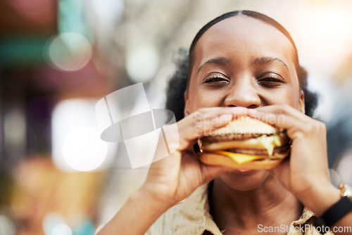 Image of Portrait, fast food and black woman eating a burger in an restaurant or outdoor cafe as a lunch meal craving. Breakfast, sandwich and young female person or customer enjoying a tasty unhealthy snack