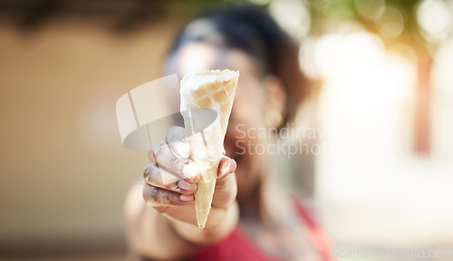 Image of Black girl, hand and ice cream outdoor in closeup for snack in summer or vacation with blurred in background. Dessert, melting and cone on holiday with person holding tasty and fresh sweet food.