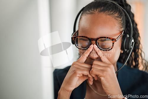 Image of Call center stress, eye strain or black woman with headache pain due to burnout fatigue in a telecom office. Anxiety, glasses or tired consultant depressed or frustrated by long hours or migraine