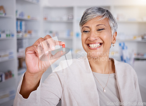 Image of Pill, medicine and woman pharmacist happy for medical treatment in a pharmacy, dispensary or drugstore for health. Senior, healthcare and professional with a antibiotics drug for research in a clinic