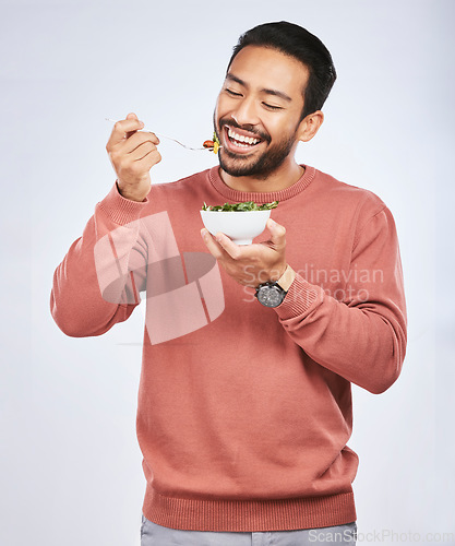 Image of Health studio, happy man and eating salad, vegetables or green food meal for diet, healthy lunch or wellness nutrition. Nutritionist, lettuce bowl and hungry male vegetarian on white background