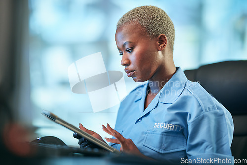 Image of Security, working and black woman with tablet at a desk for communication, cctv app or building monitor. Digital, reading and an African safety officer typing on technology for a surveillance system