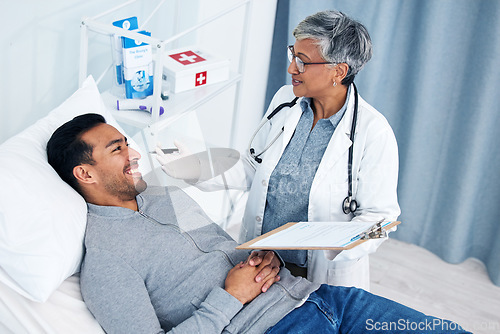 Image of Man, doctor and medical test with talking and senior professional at a hospital for support. Wellness, consultation and patient at a clinic for expert advice and health insurance with clipboard