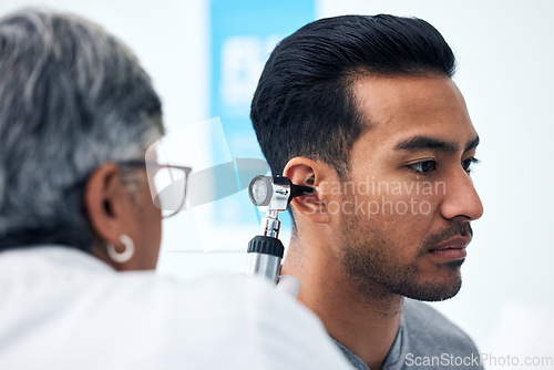 Image of Ear check, man and ENT doctor with patient consultation for hearing and wellness at hospital. Senior, employee and otoscope test of physician with healthcare work and consulting exam with expert
