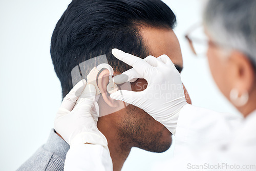 Image of Hearing aid, deaf man and doctor hands with patient consultation for ear and ENT check at hospital. Help, employee and medical test of physician with health insurance and consulting exam with expert