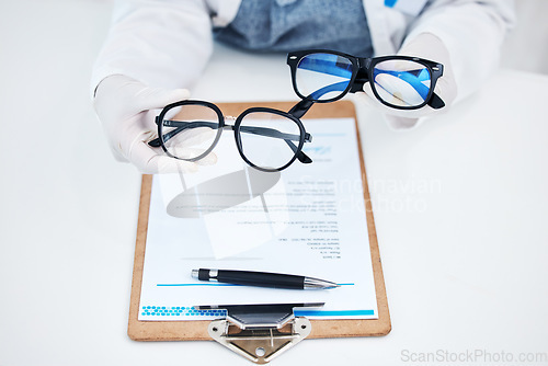 Image of Hands, vision and glasses test with consulting and healthcare contract in consultation with support. Hospital, lens care and paperwork with doctor and ophthalmologist holding eyewear in clinic