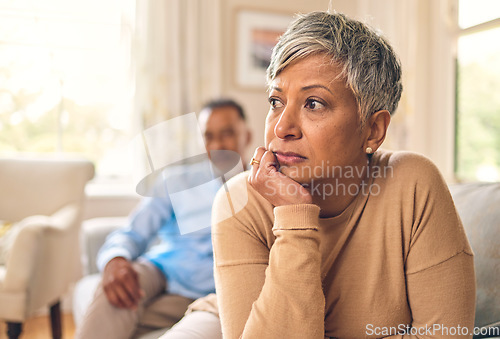 Image of Divorce, fight and mature woman is sad in living room with partner at home with depression or thinking. Conflict, wife and marriage with infidelity is upset on sofa with couple, cheating, frustrated.