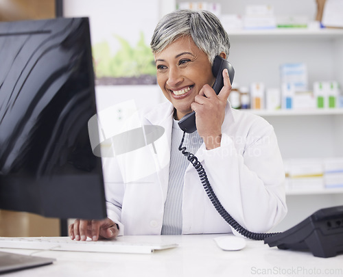 Image of Pharmacist, telephone and computer for prescription with woman in conversation for retail healthcare. Chemist, working and pharmacy on computer with customer service or medicine with telehealth.