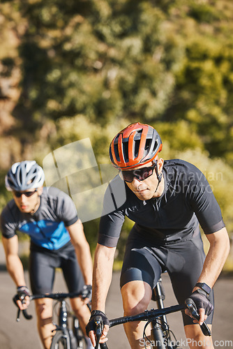 Image of Men, mountain and cycling for race, fitness and helmet for safety, speed and training for health in summer. Young cyclist athlete, focus and exercise for wellness, performance and workout in sunshine