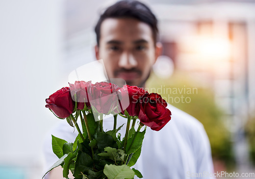 Image of Love, giving and man with bouquet of roses for date, romance and hope for valentines day. Confession, romantic gift and person holding flowers outside, proposal or engagement on blurred background.