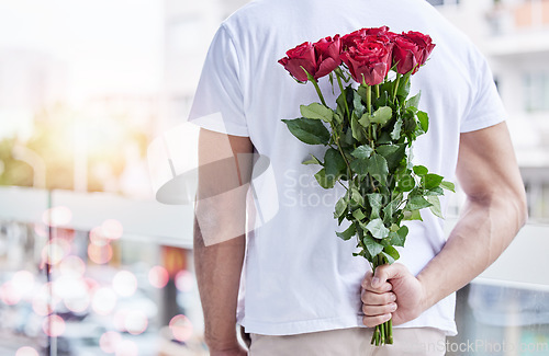 Image of Love, surprise and man with roses behind back for date, romance and hope for valentines day. Romantic confession, floral gift and person with bouquet of flowers in city for proposal or engagement.